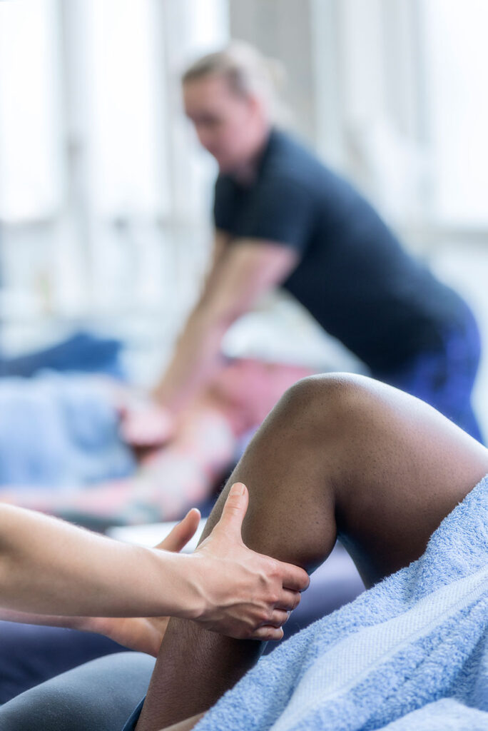 therapist massaging leg