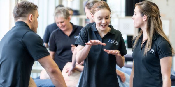 students and tutor on Level 5 massage course chatting