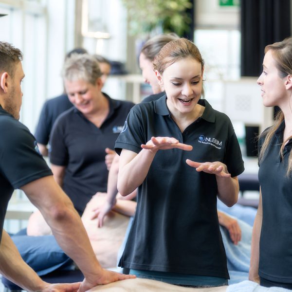 students and tutor on Level 5 massage course chatting